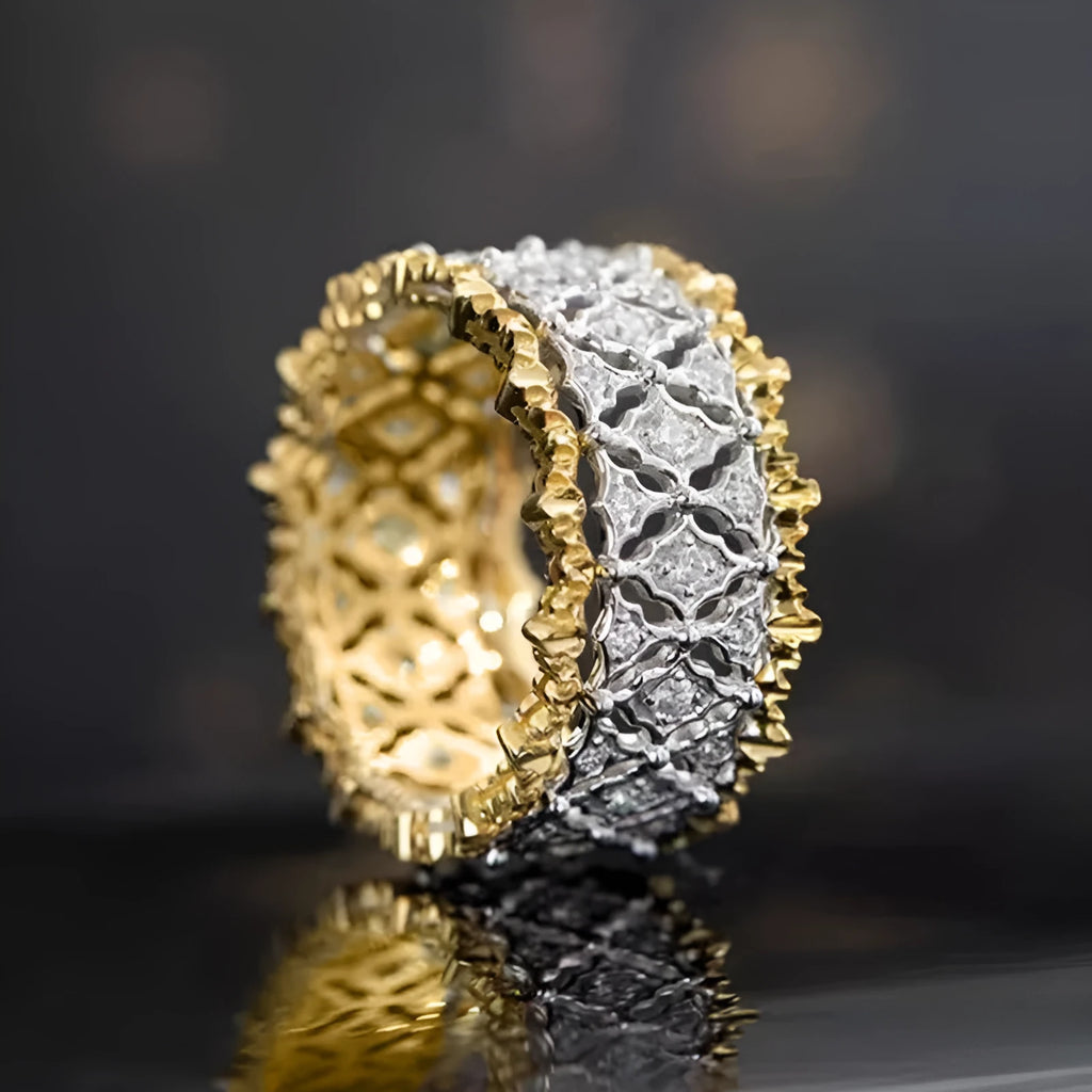 Geometric two-tone copper ring with a round central zircon stone, shown on a finger.