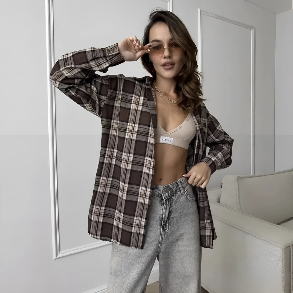 Dark brown striped women's long sleeve shirt in retro style on a hanger