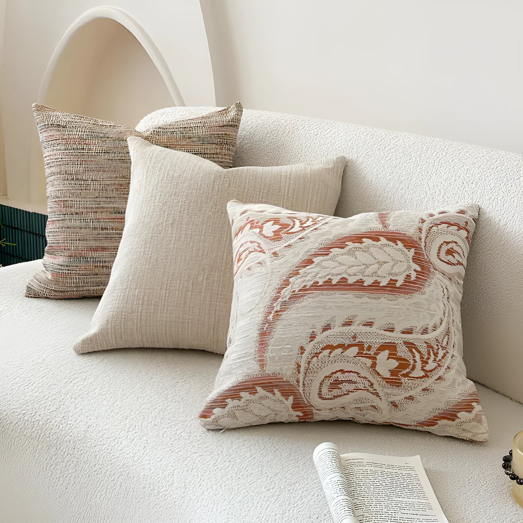 American-style jacquard woven throw pillow cover with a paisley pattern in amber colours on a sofa.