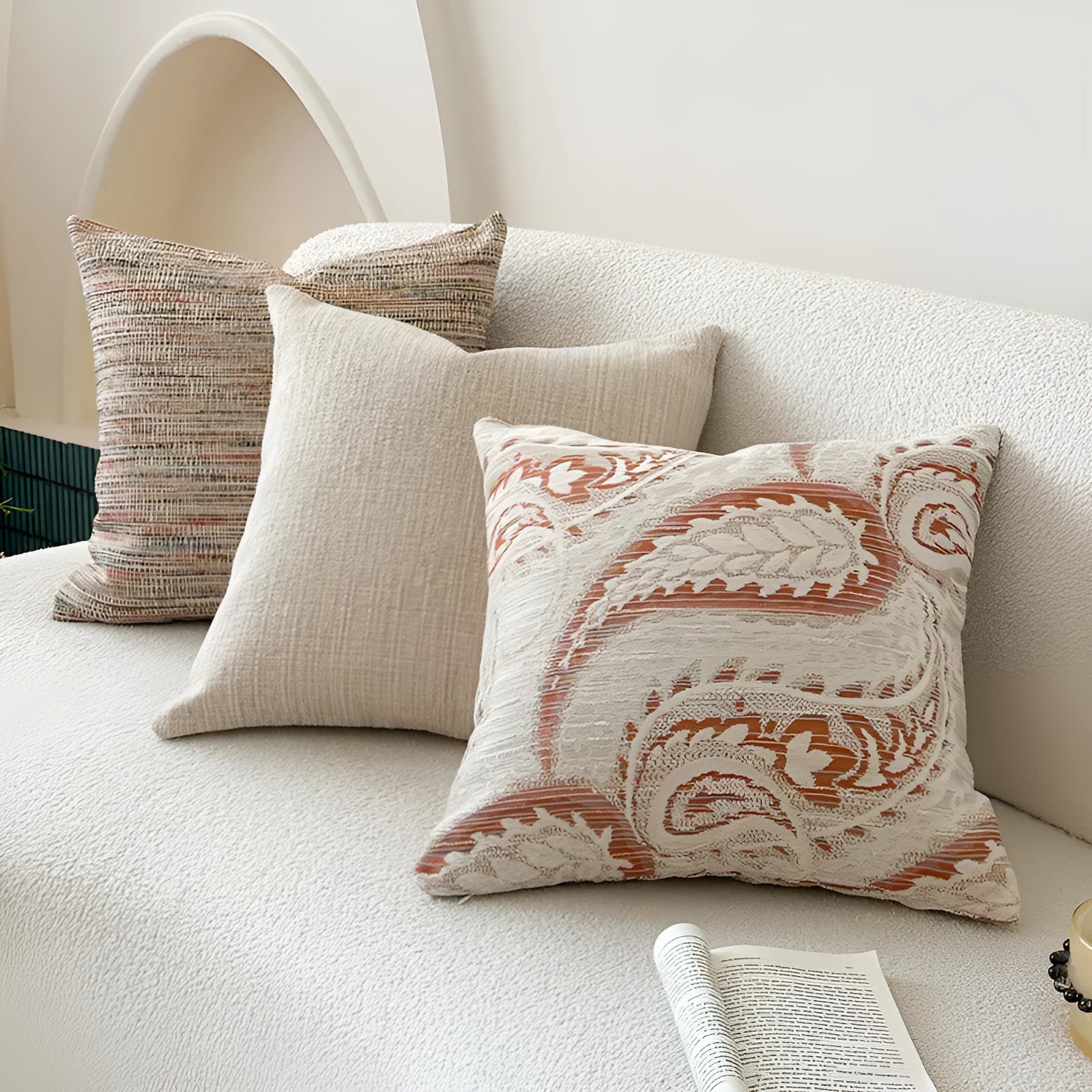 American-style jacquard woven throw pillow cover with a paisley pattern in amber colours on a sofa.