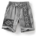 Man wearing blue colour block print loose casual shorts with lace-up waist.