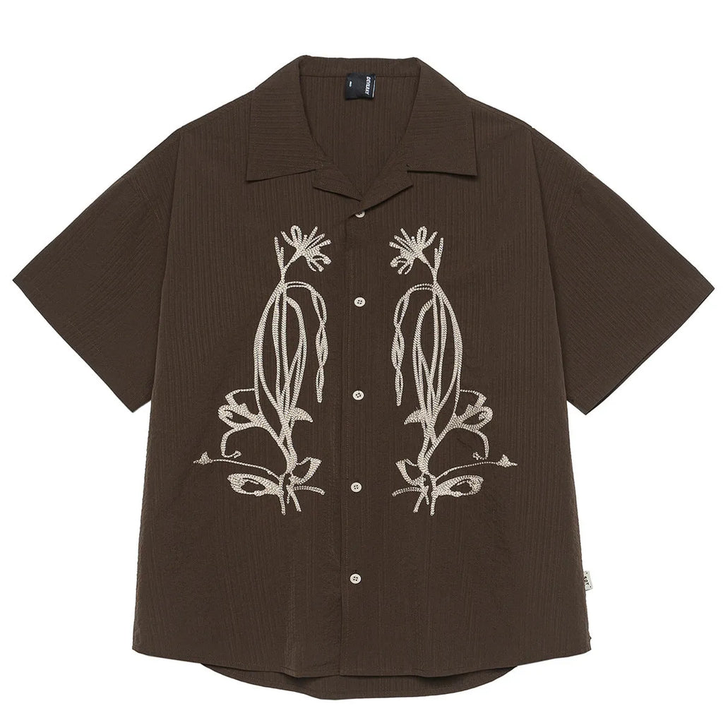 Brown striped men's short sleeve outdoor shirt with a Cuban collar on a hanger
