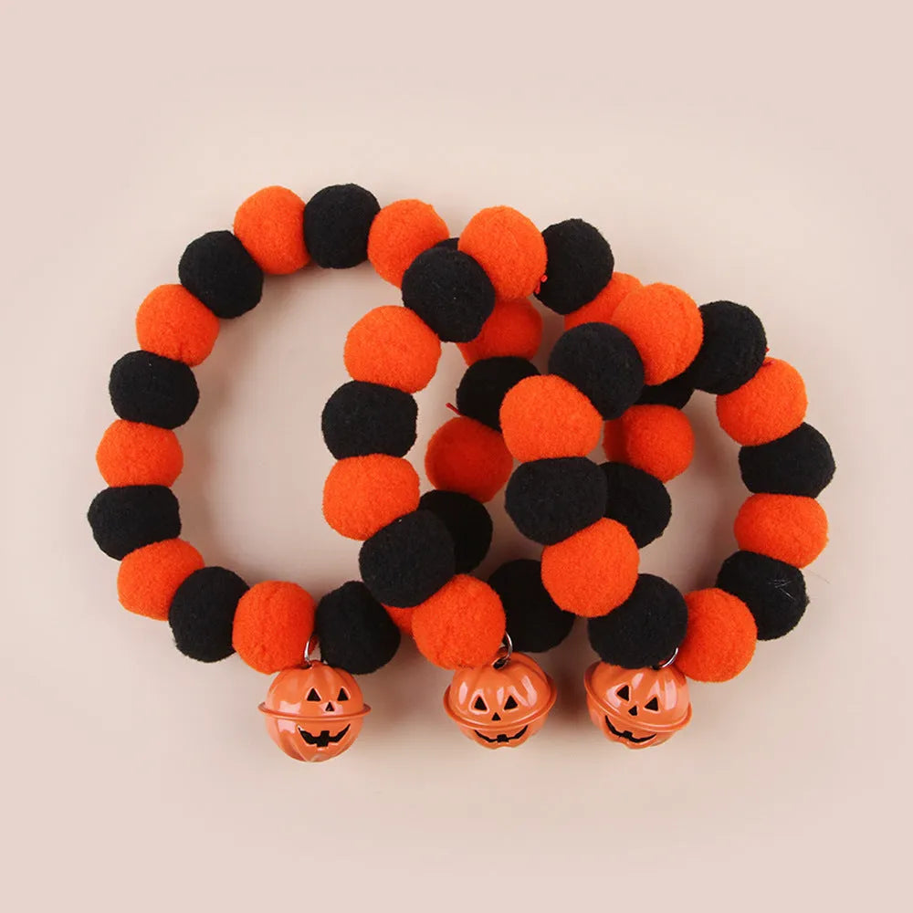 Orange cat collar with a black Halloween pumpkin print and 'trick or treat' text, shown with a buckle.