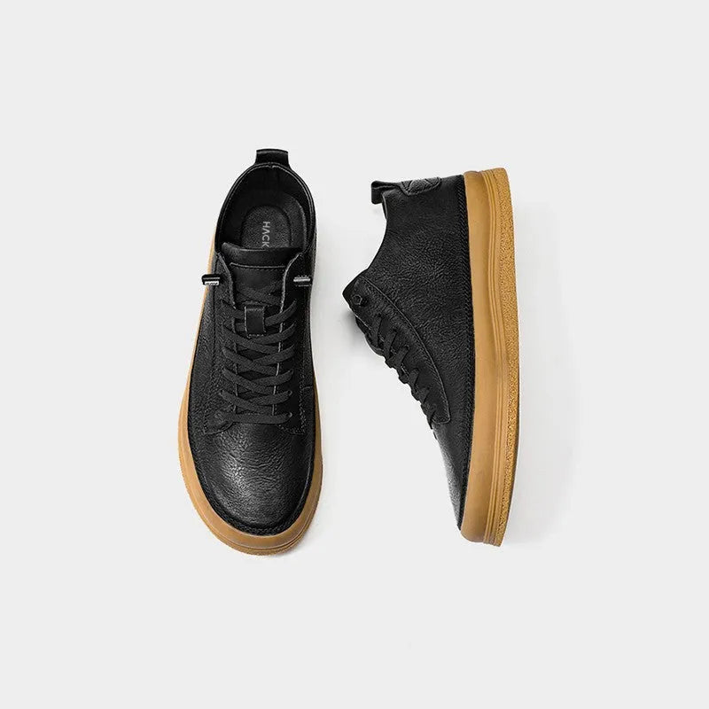 Men's black leather casual shoes with round toe, flat heel, and laced closure on soft rubber sole