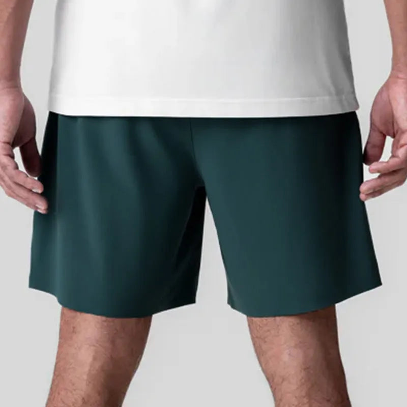 Men's grey seamless sports shorts with a straight-leg, knee-length cut on a mannequin.