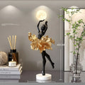 Small modern night lamp ornament in resin showing colour options: black gold, white, pink, and light blue.