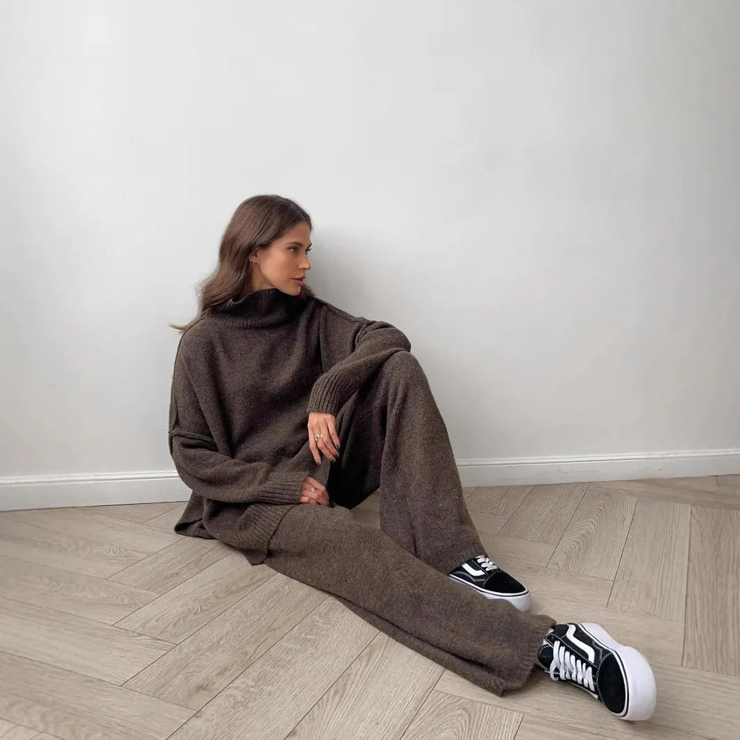 Women's dark grey knit co-ord suit with side-slit sweater top and matching trousers.