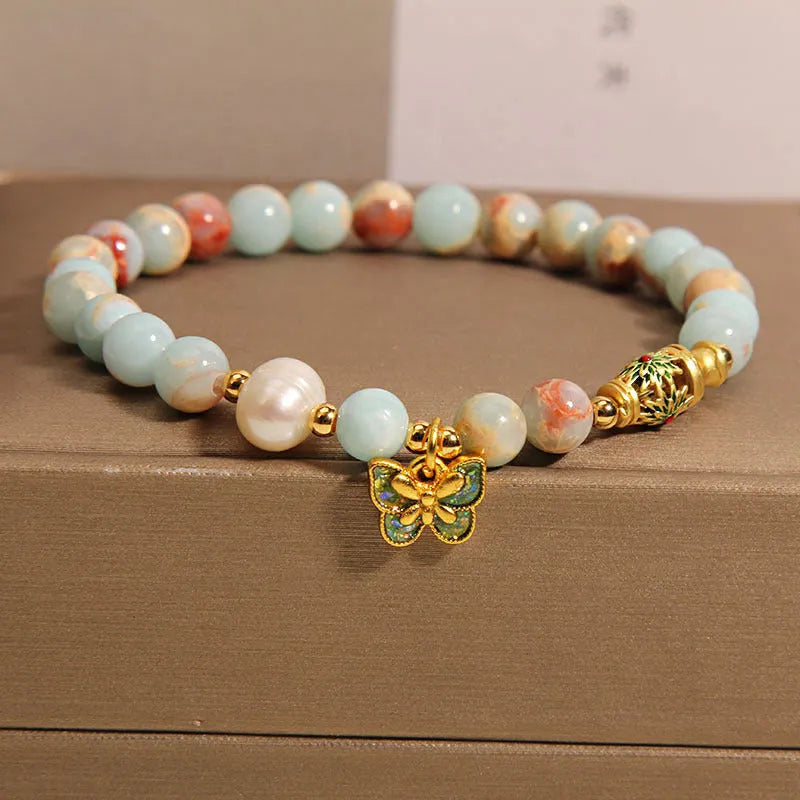 Blue freshwater pearl bracelet with Shoushan stone elements and butterfly pendant.