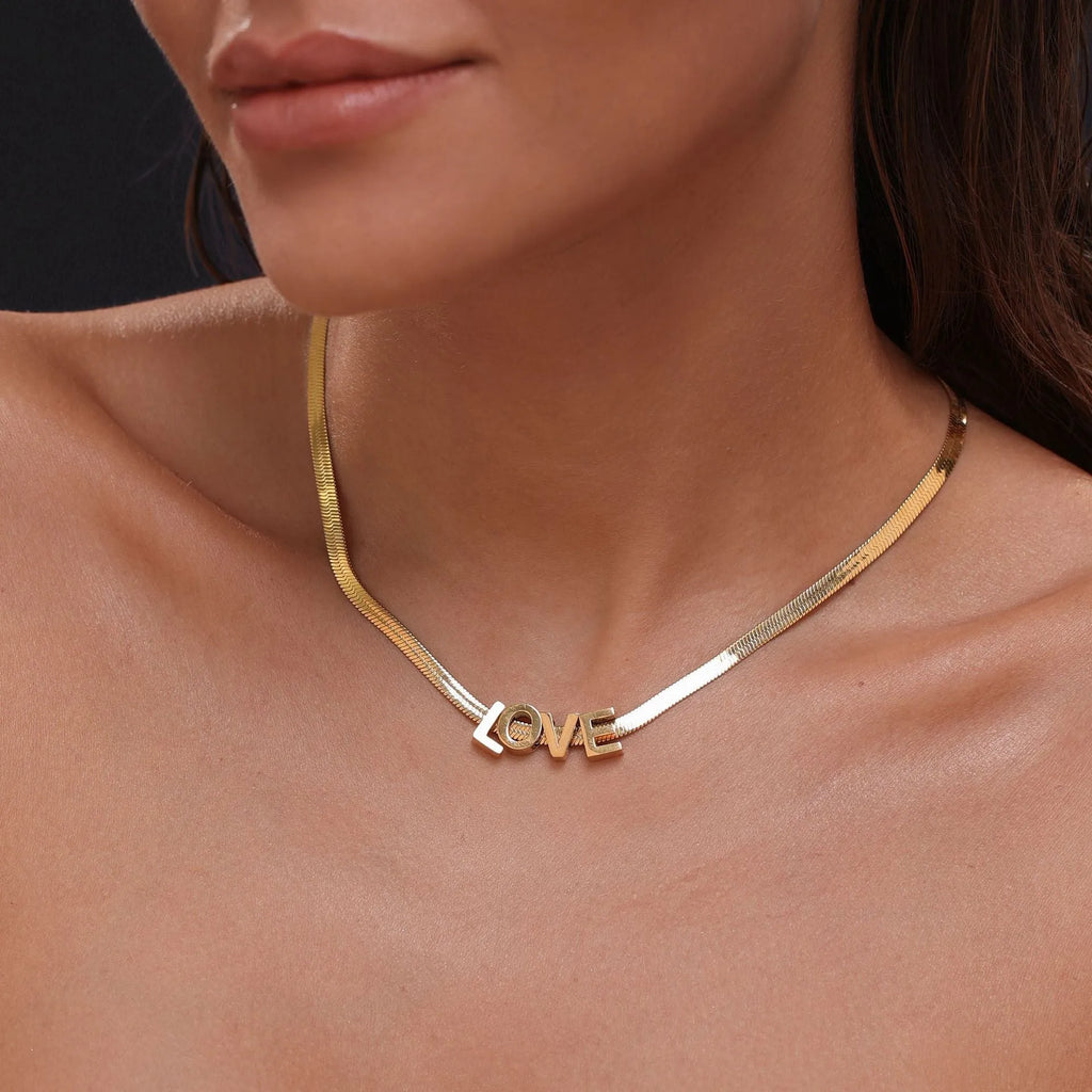 Gold electroplated titanium steel necklace showing letter A pendant on a 40.5cm blade chain
