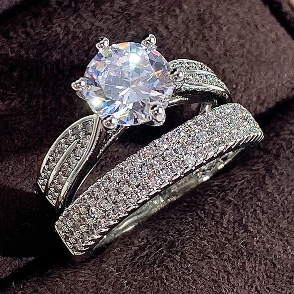 White gold colour alloy combined ring and bracelet with geometric shape and round details.
