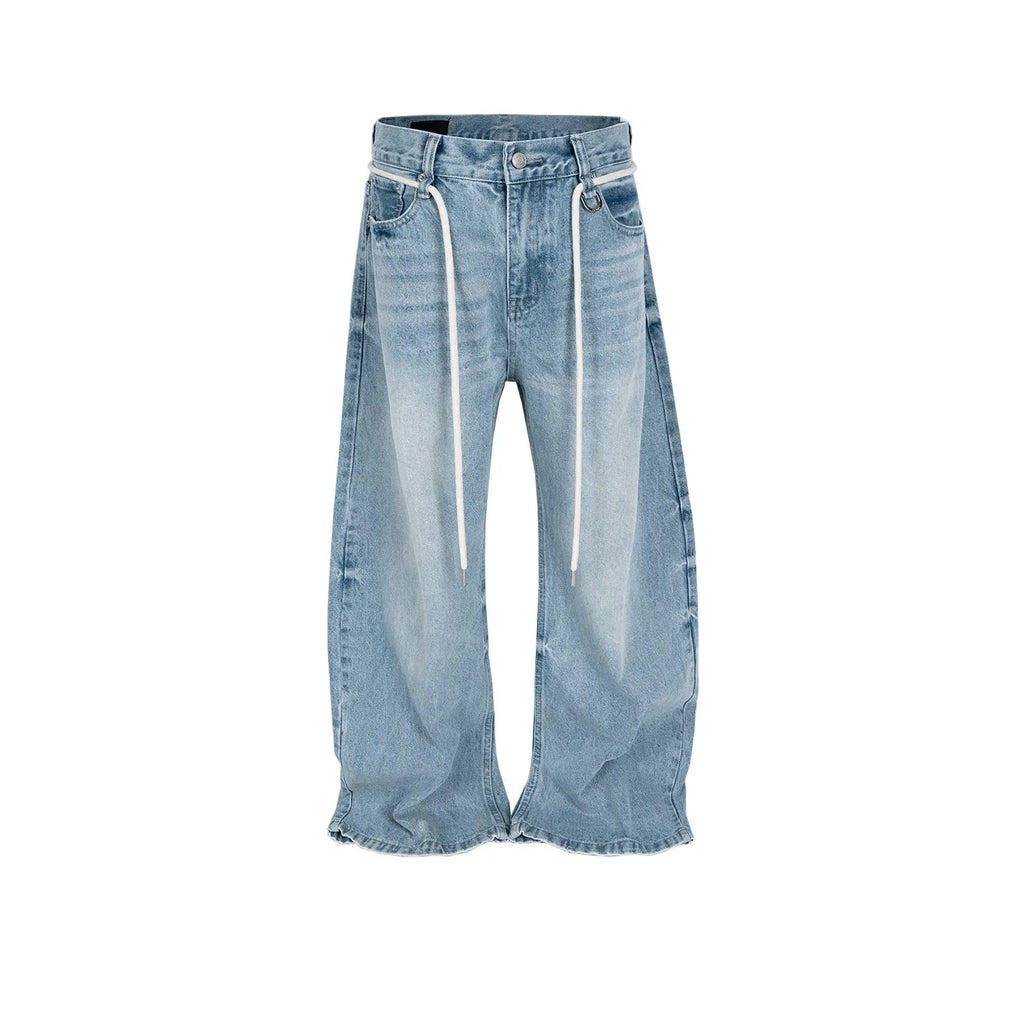 Blue vintage washed straight-leg denim trousers with drawstring belt laid flat