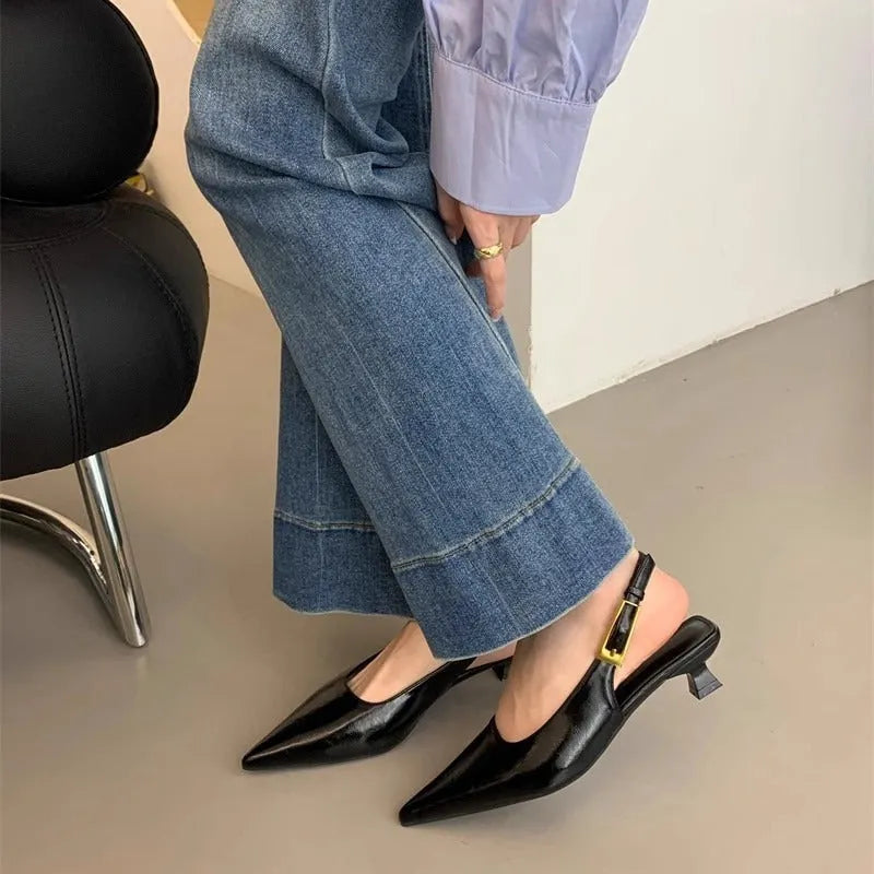 Thin low heel strap pointed leather shoes in black, red, brown, or silver on a rubber sole.