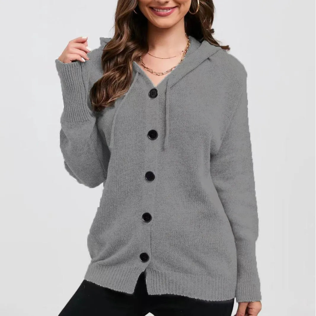 A woman wearing a loose-fit, solid-colour hooded cotton cardigan sweater.