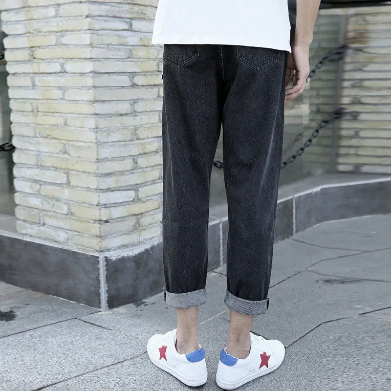 Men's black straight leg harem jeans with college-inspired styling on hanger