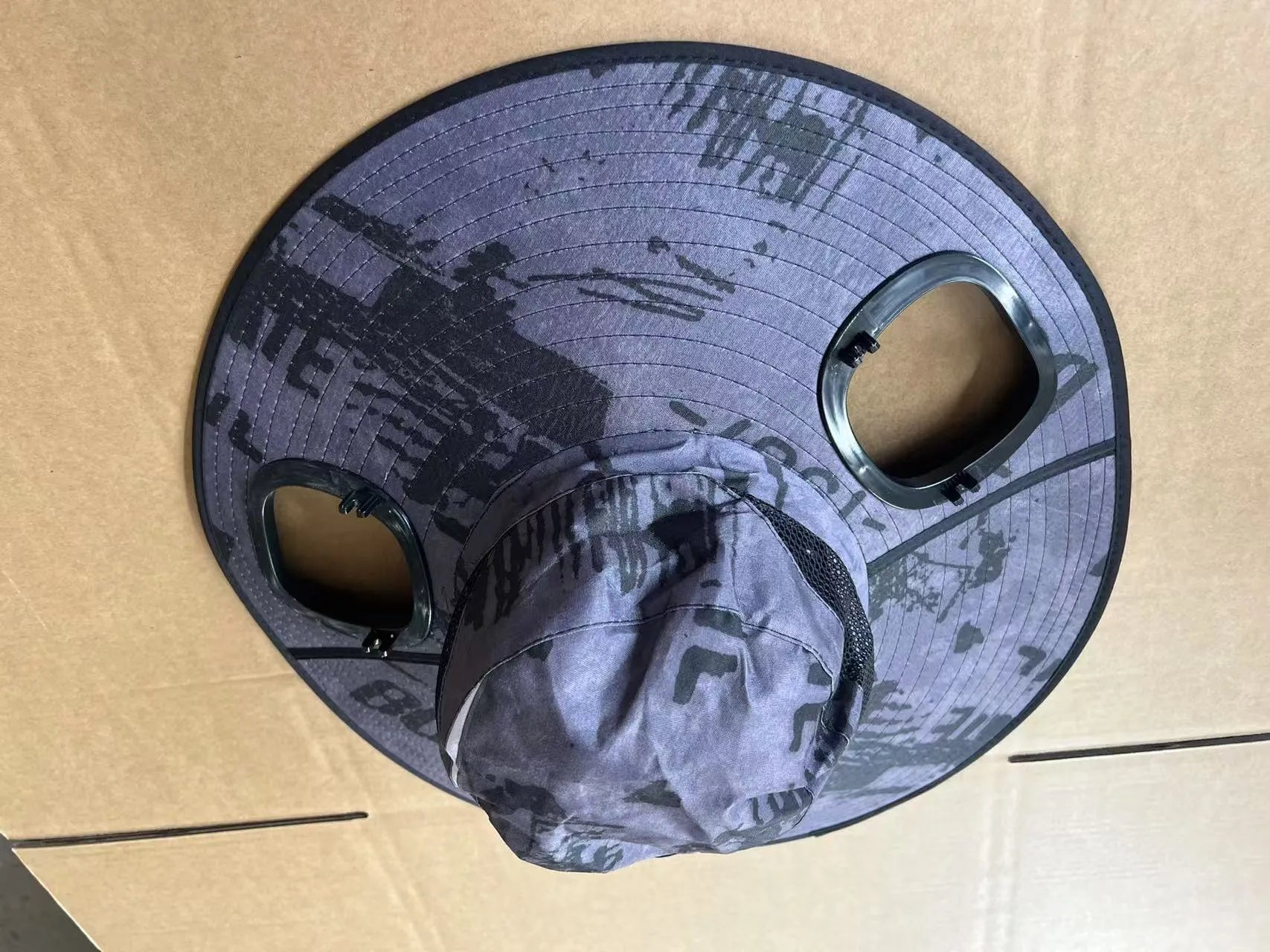 Men's grey sun shading cap with large eave and integrated solar fan for outdoor cooling