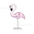 Pink crystal simulation flamingo decorative ornament on a table for home decor or gifting.