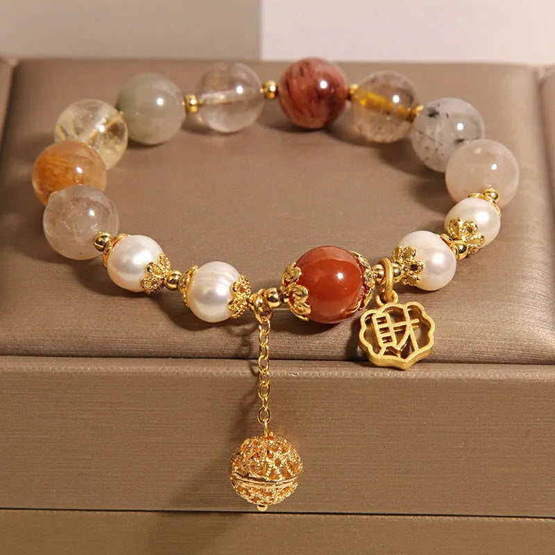 Women's crystal bracelet with colourful hair crystal beads, four pearls, and a Chinese Cai charm.