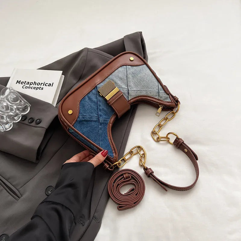 Brown denim women's bucket shoulder bag with diamond mesh detail and chain strap connector.