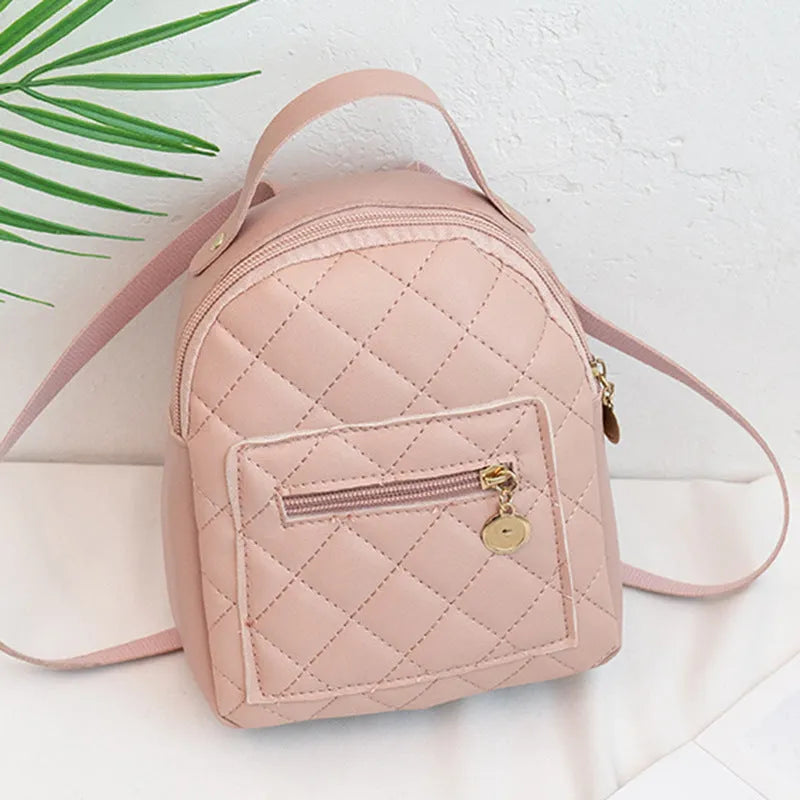 Girls' hard-case embroidered backpack in pink, showing front design and shoulder straps.