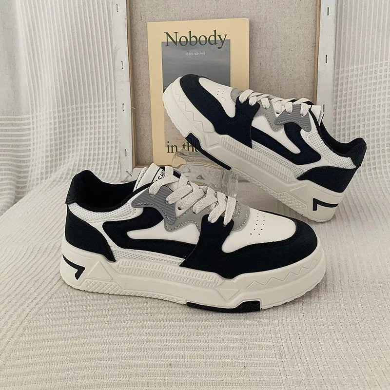 Women's low-top thick bottom casual skate shoes in black with rubber sole and front lace-up closure