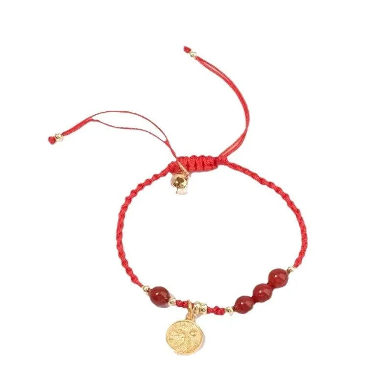 Cinnabar bracelet with braided rope in three colour options featuring round bead or flower blessing card charms