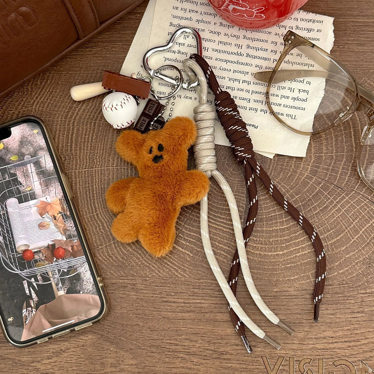 Soft plush brown bear doll pendant keychain hanging on a bag, with a cute bear/piglet animal pattern