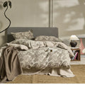 Linen cotton bedding four-piece set with jacquard plant pattern on a 1.5m double bed in Jinlan Gray colourway