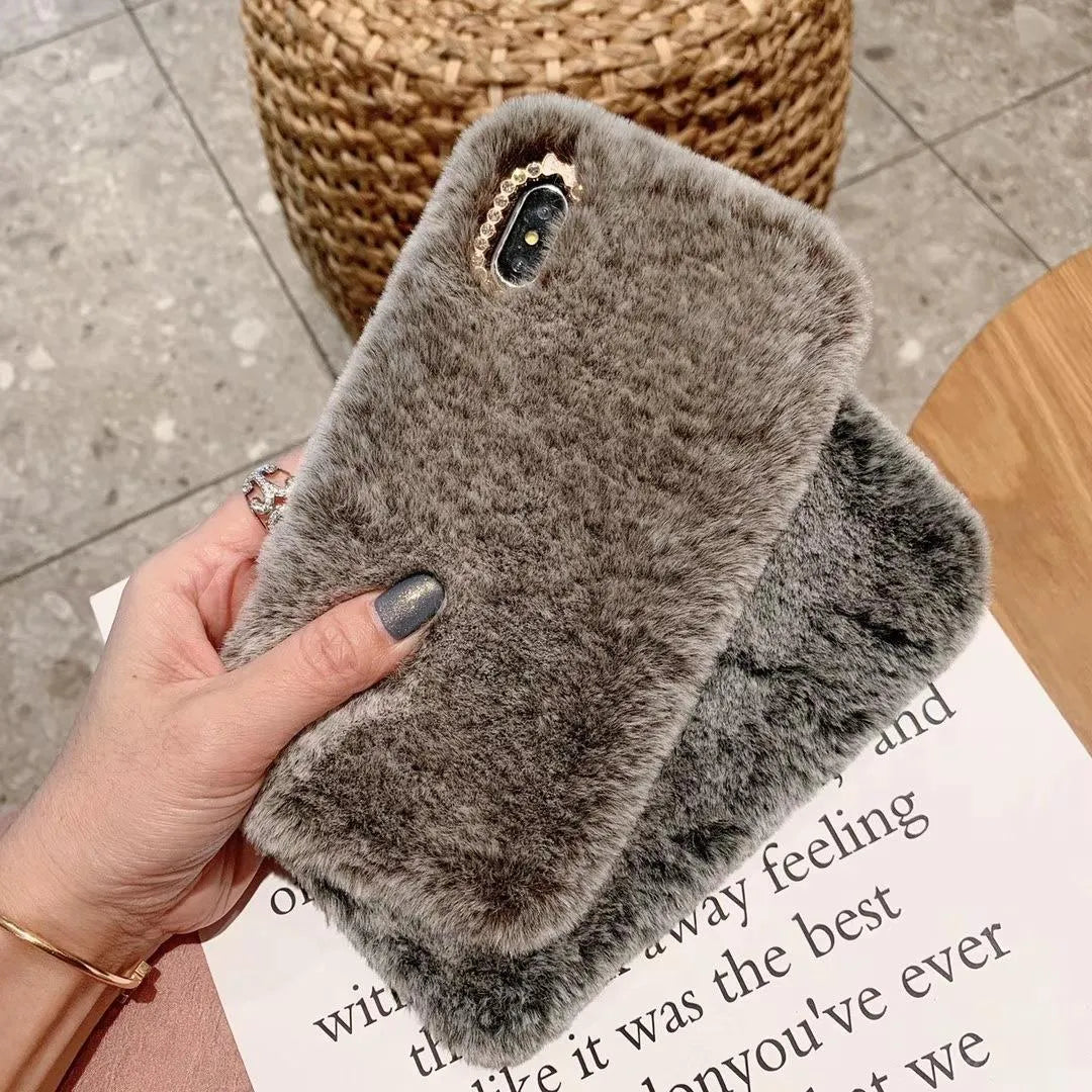 Silicone iPhone case with grey faux rabbit hair plush back and rhinestone decoration.