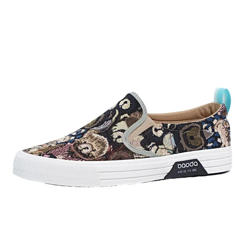 A pair of low-top canvas slip-on sneakers with a round toe and vulcanised rubber sole on a neutral background.