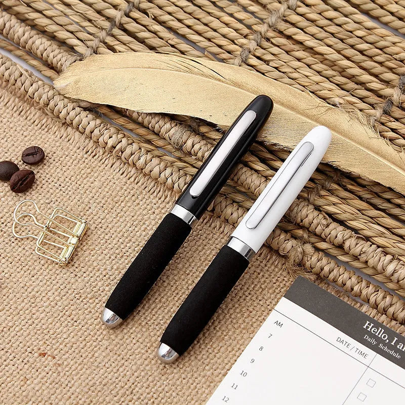 Close-up of a silver EVA metal cap mini ballpoint pen with a 1.0 mm bullet tip, shown with a bright black refill.