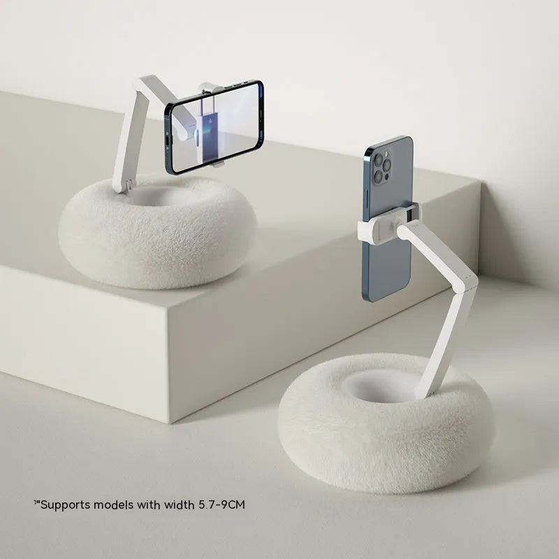 Adjustable rotating bracket holding a tablet, showing vertical extension rod and fabric-covered base.