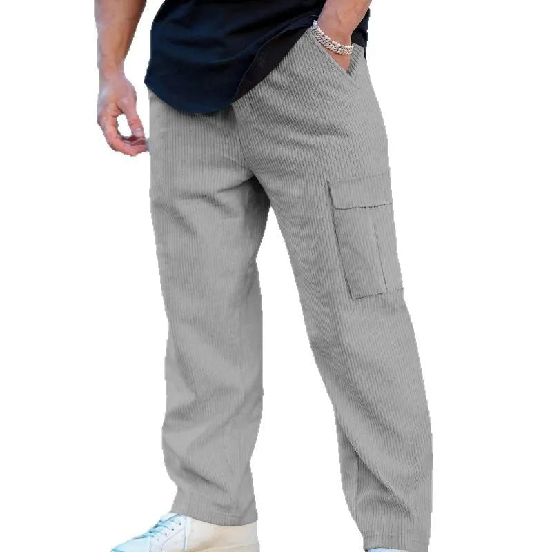 Men's navy blue corduroy cargo trousers with loose fit and straight legs on a hanger.