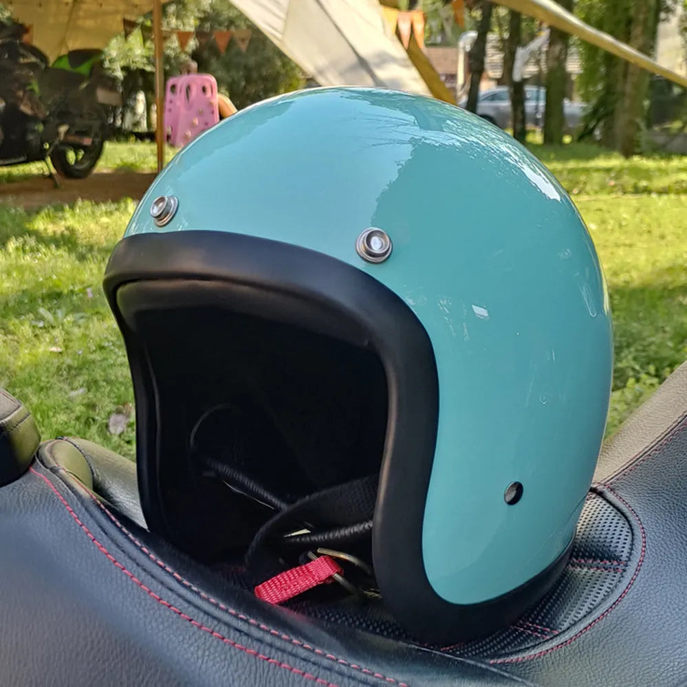A retro-styled half motorcycle helmet made from glass fibre, shown in a matte black flower colour finish.