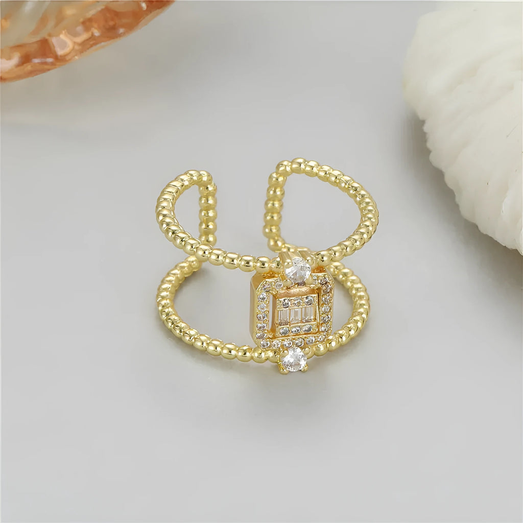 Gold-coloured adjustable open ring with an asymmetric U-shaped design on a white background.