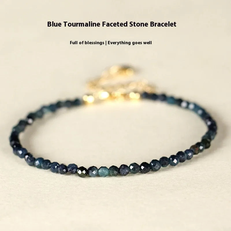 Women's blue tourmaline bracelet with 3mm beads and spacer bead design.