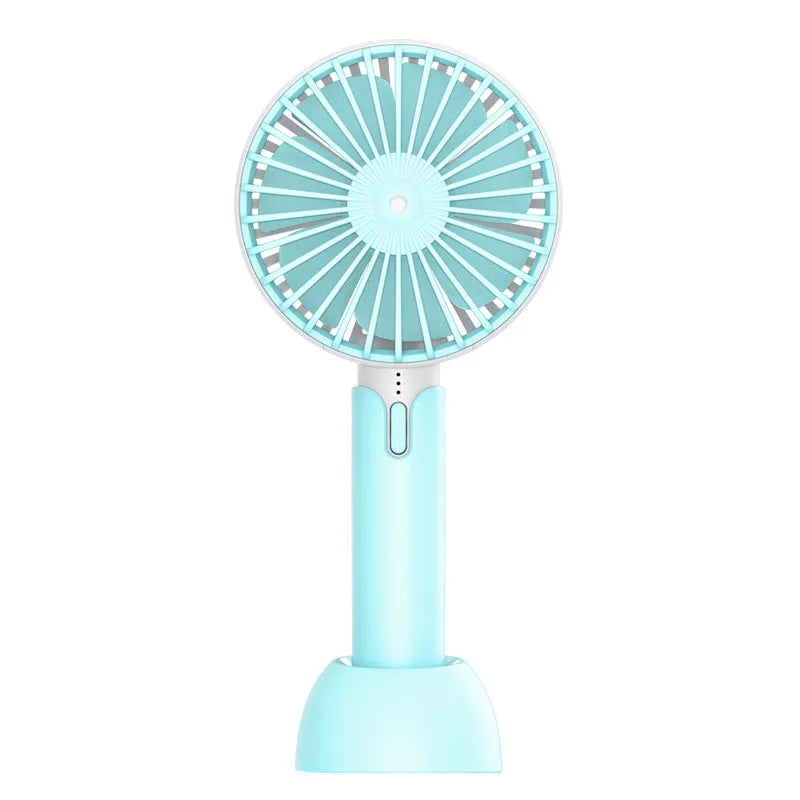 Blue handheld USB mini electric fan with three-speed control on a desk.