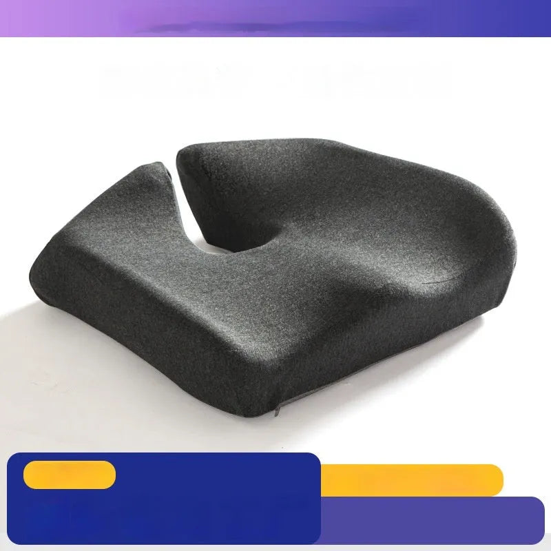 A black memory foam office chair cushion measuring 36 by 40 centimetres on a desk chair.
