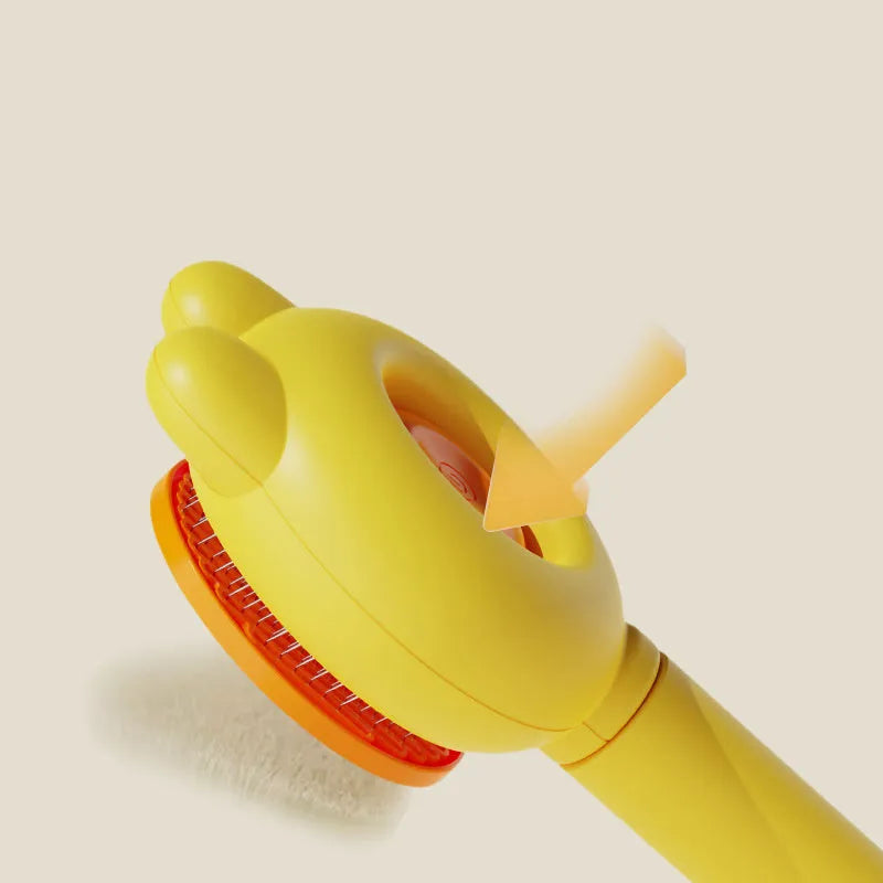 Self-cleaning pet brush with green handle and stainless steel teeth, showing release button mechanism