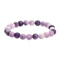 Purple geometric stone bead elastic bracelet for men and women on a wrist.
