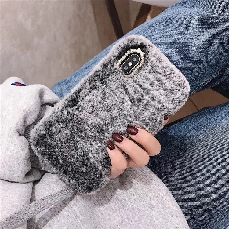 Silicone iPhone case with grey faux rabbit hair plush back and rhinestone decoration.