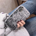 Silicone iPhone case with grey faux rabbit hair plush back and rhinestone decoration.