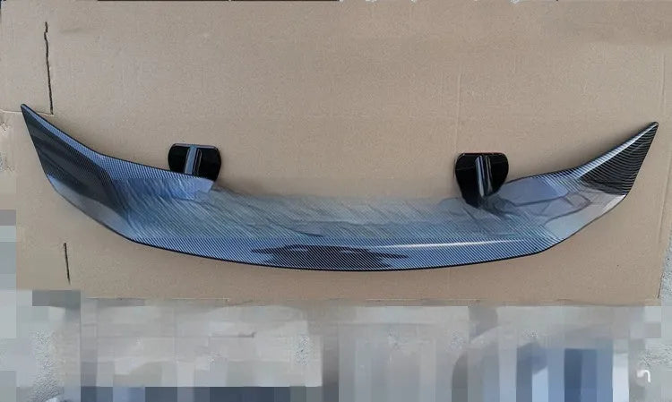 A universal punch-free ABS plastic car tail wing spoiler showing bright black, white, and carbon pattern finish options.