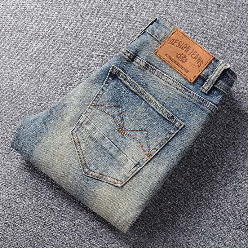Men's retro straight-leg jeans in distressed blue washed denim with mid waist, zip fly and multiple pockets