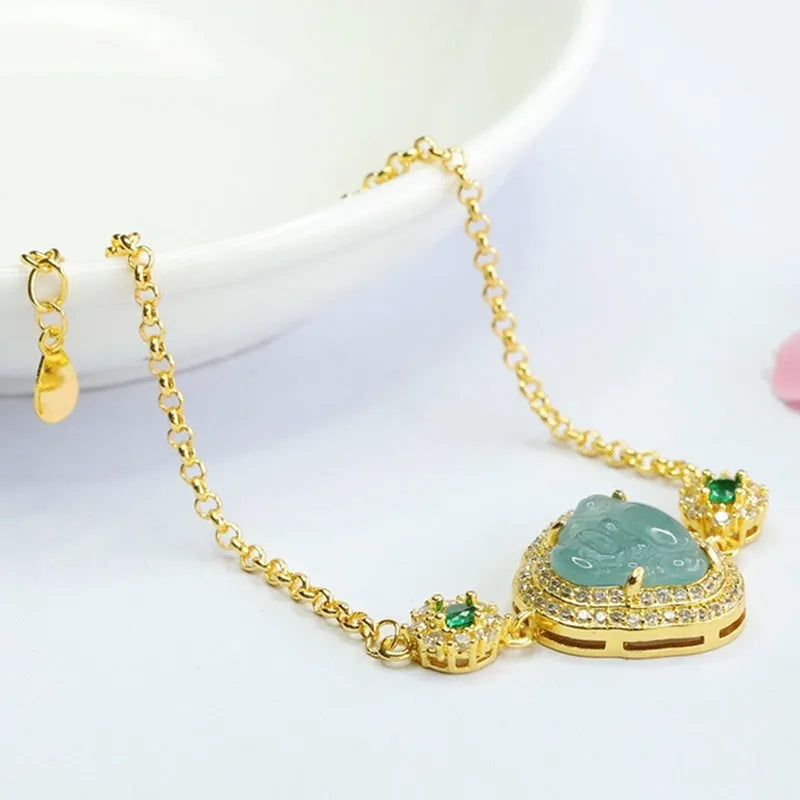 Women's jade bracelet with an inlaid blue Maitreya Buddha charm measuring 10mm by 13mm.