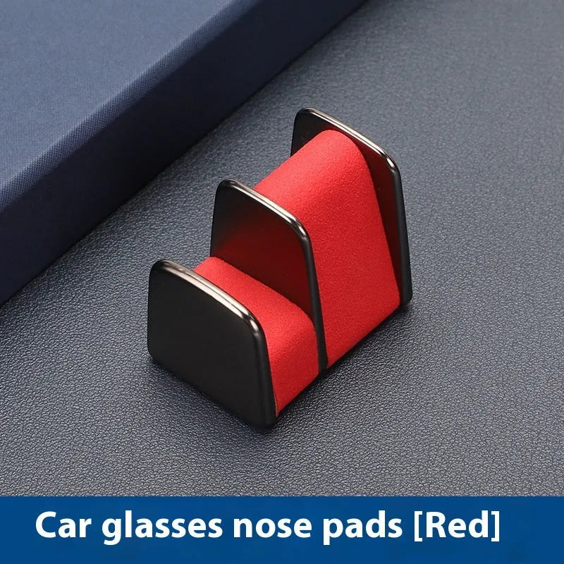 Zinc alloy and leather car dashboard glasses clip holder in green, shown on a car dashboard.