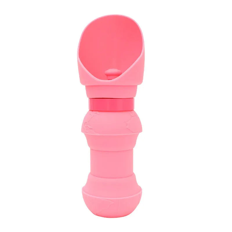 A pink silicone folding cup for pets, shown both expanded as a water bowl and collapsed flat for storage.