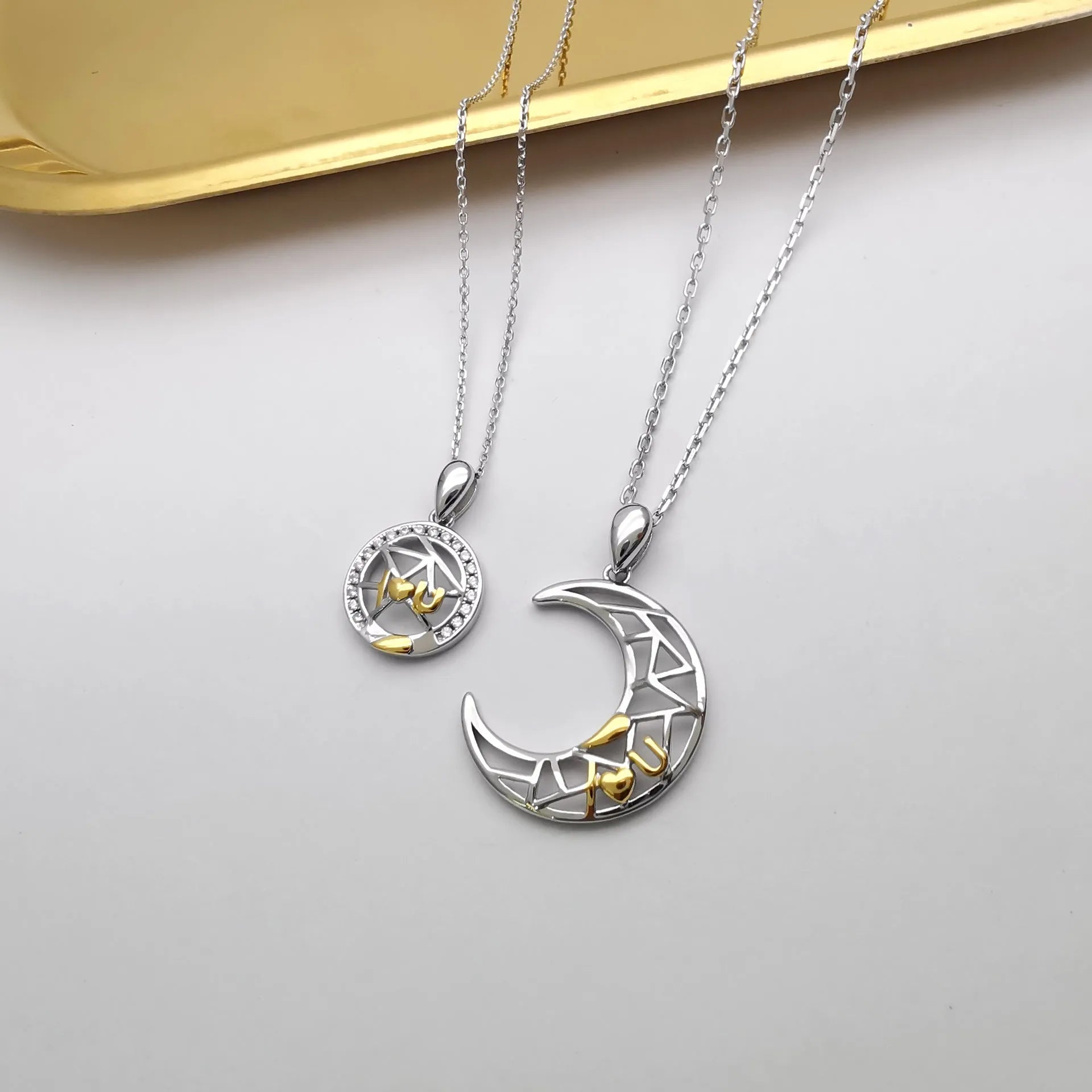 Copper sun and moon couple necklace with electroplated finish and cross chain.