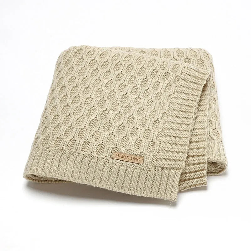 Solid colour baby hug blanket with raised line texture, shown in a light green colour.