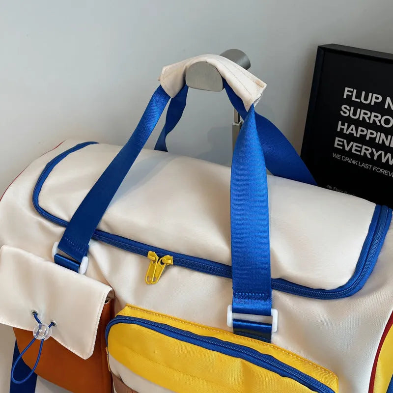 Fashion colour contrast multi-pocket cloth travel bag with blue and white accents on a plain background