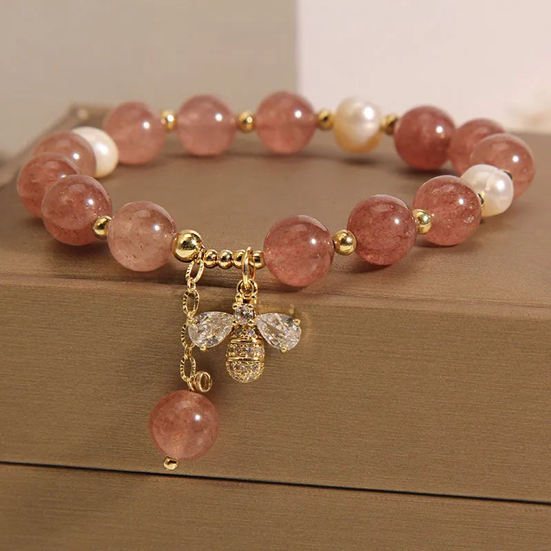 Women's bracelet with strawberry quartz beads, freshwater pearls, and zircon accents on an alloy setting.